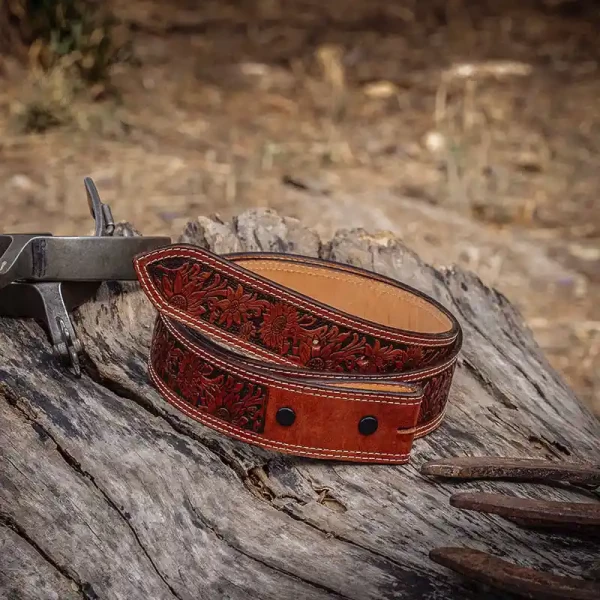 A brown full grain leather belt for women featuring tooled sunflower pattern 